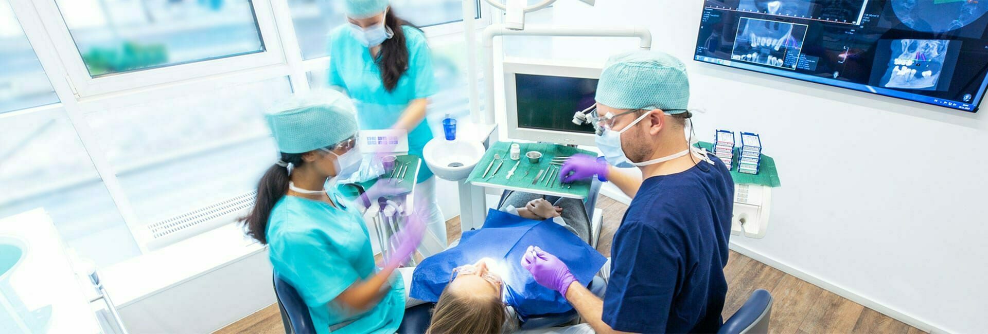 Zahnarzt und Zahnarzthelferin führen Operation für ein Keramikimplantat durch